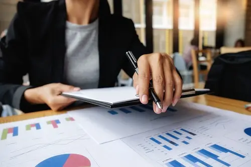 Woman working on a plan in an office environment, focused on career growth and success